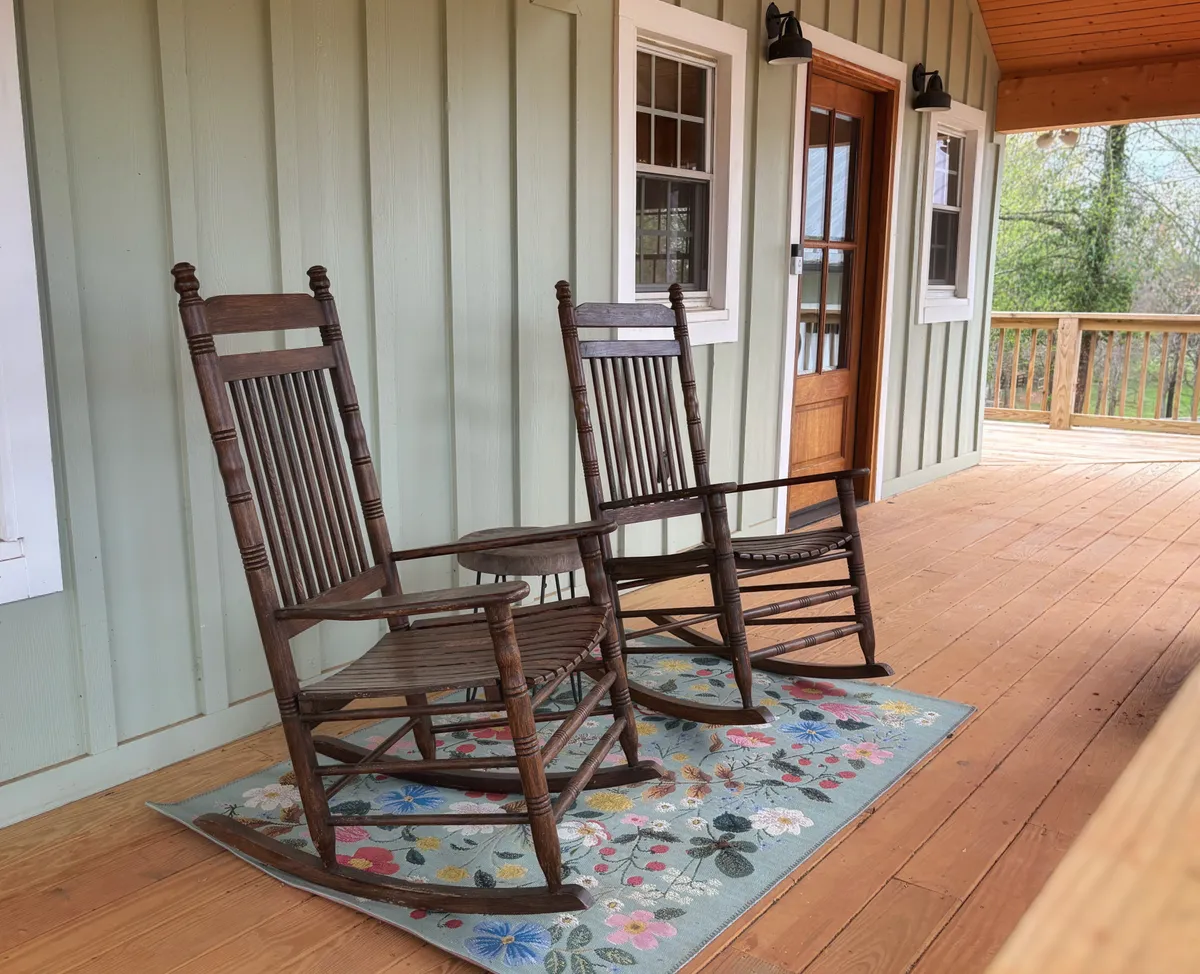 Two rocking chairs on the cottage porch, where the long version of the story gets told
